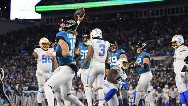 Jacksonville Jaguars quarterback Trevor Lawrence (16) spikes the ball after scoring a two point conversion during the fourth quarter of an NFL first round playoff football matchup Saturday, Jan. 14, 2023 at TIAA Bank Field in Jacksonville, Fla. Jacksonville Jaguars edged the Los Angeles Chargers on a field goal 31-30. [Corey Perrine/Florida Times-Union]